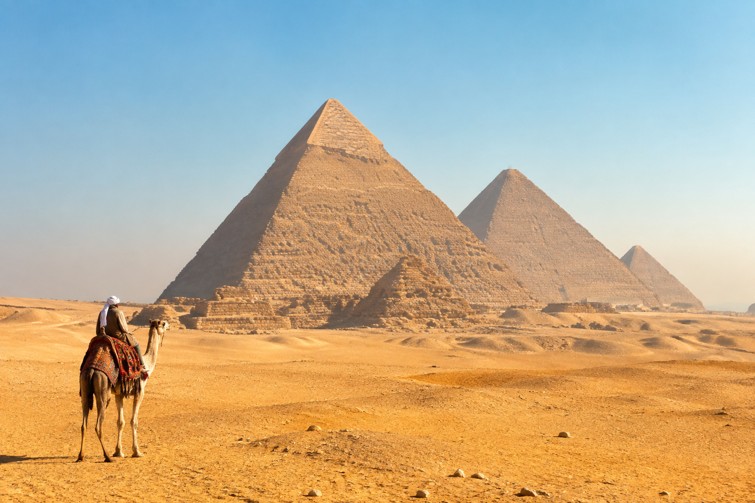 Giza pyramids and golden desert beneath a blue sky