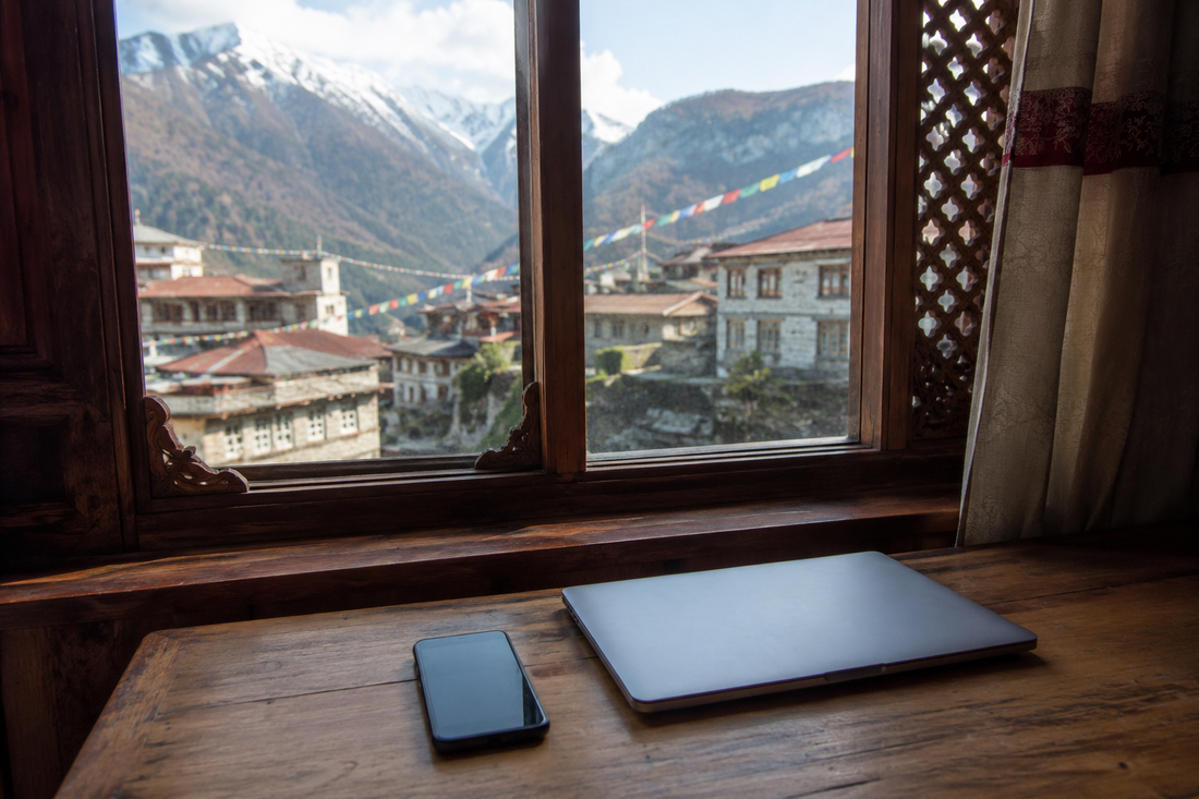 Unbranded phone and laptop on a Nepal-inspired guesthouse desk