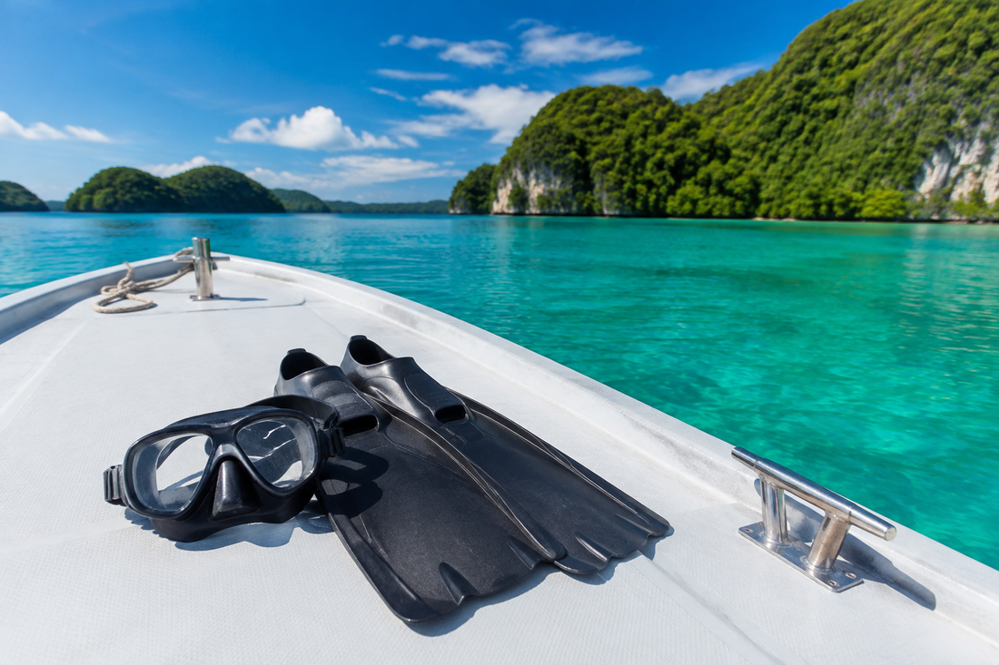 Dive mask and fins on a boat overlooking Palau-inspired limestone islands